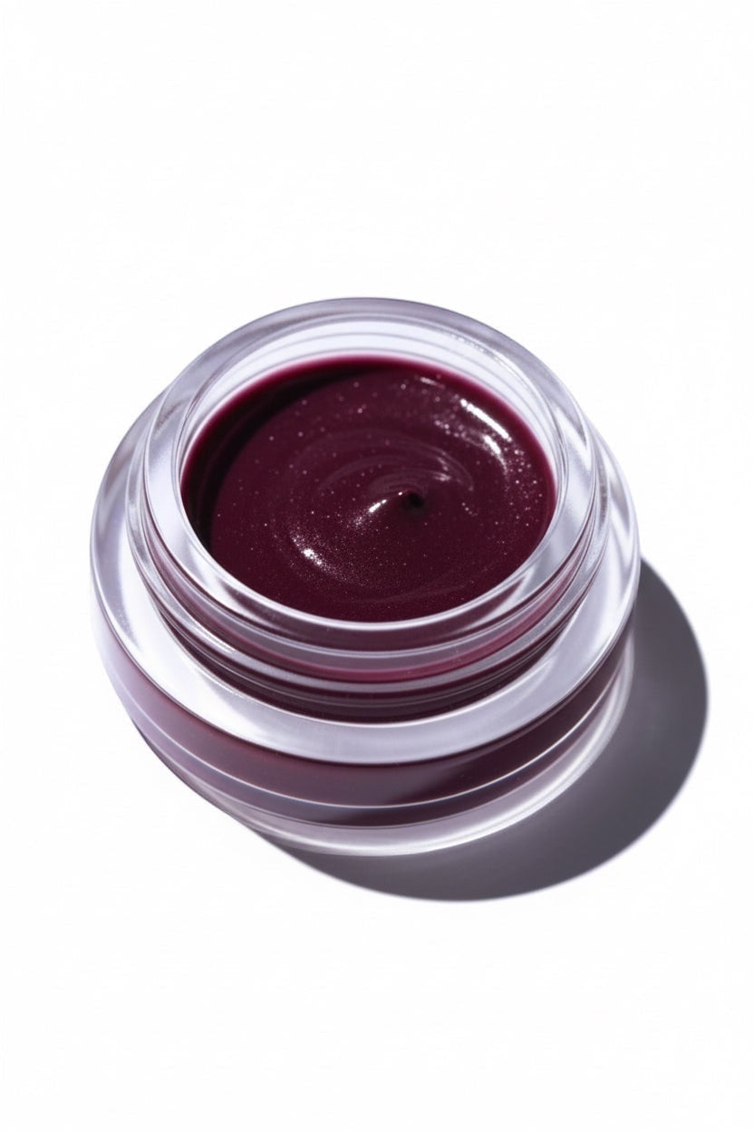 Gressa Skin La Première Fleur deep berry cream cosmetic in a clear glass jar on a white background.